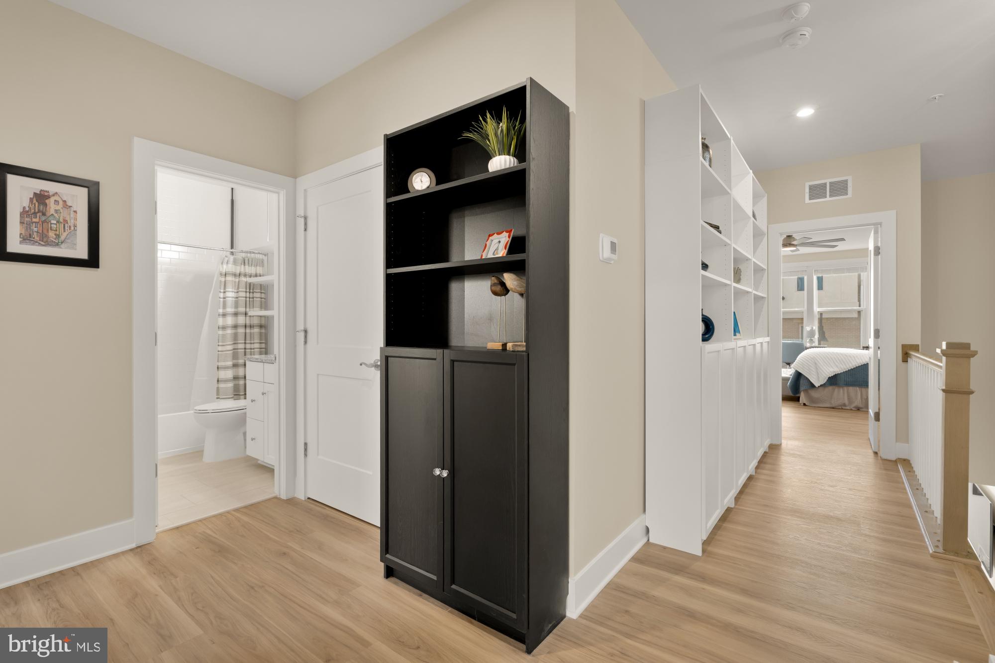 1704 Bandit Loop, Unit 20A Reston, VA 20190 - Photo 15 of 32 a view of a walk in closet and bedroom with wooden floor