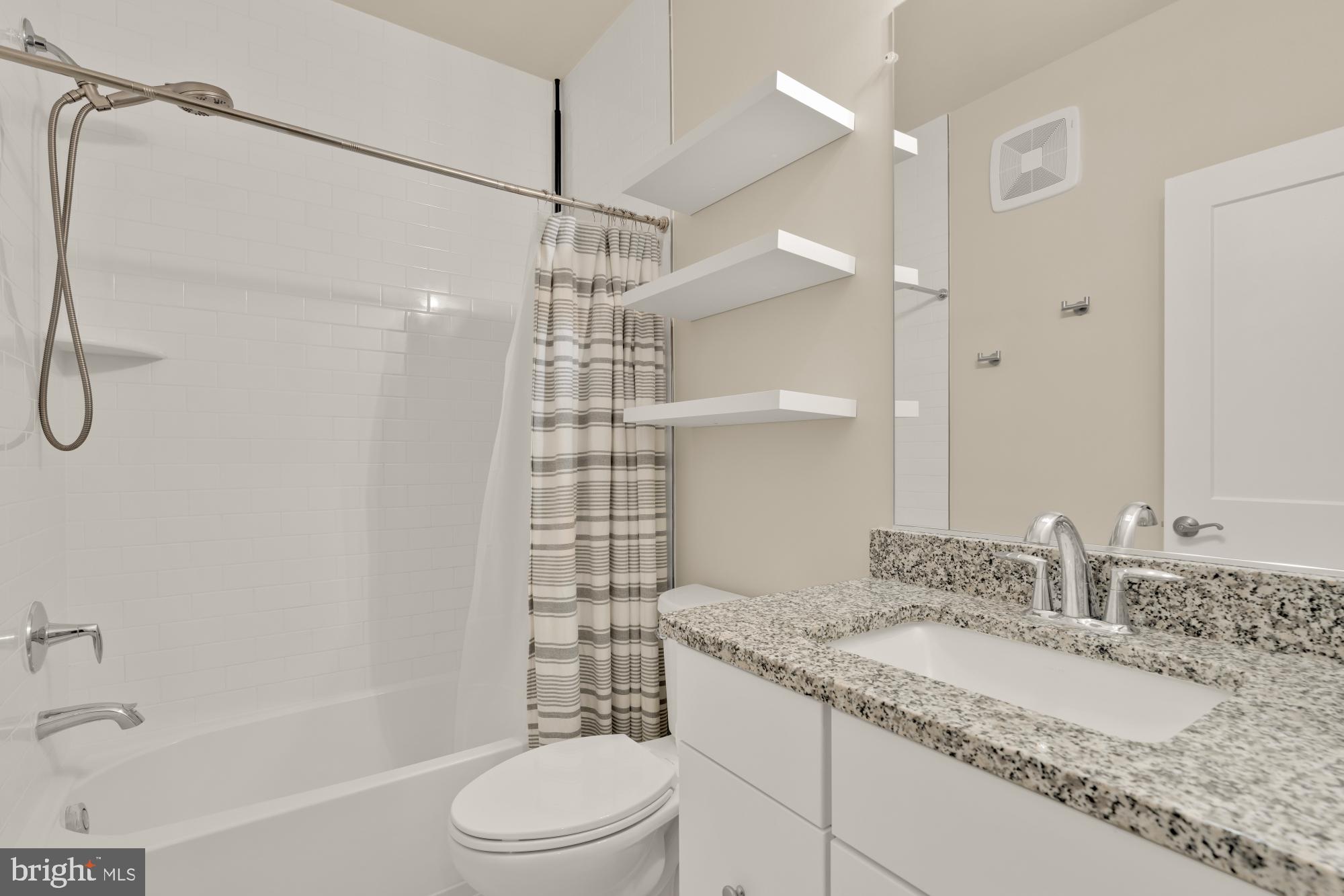 1704 Bandit Loop, Unit 20A Reston, VA 20190 - Photo 18 of 32 a bathroom with a granite countertop sink a toilet and shower