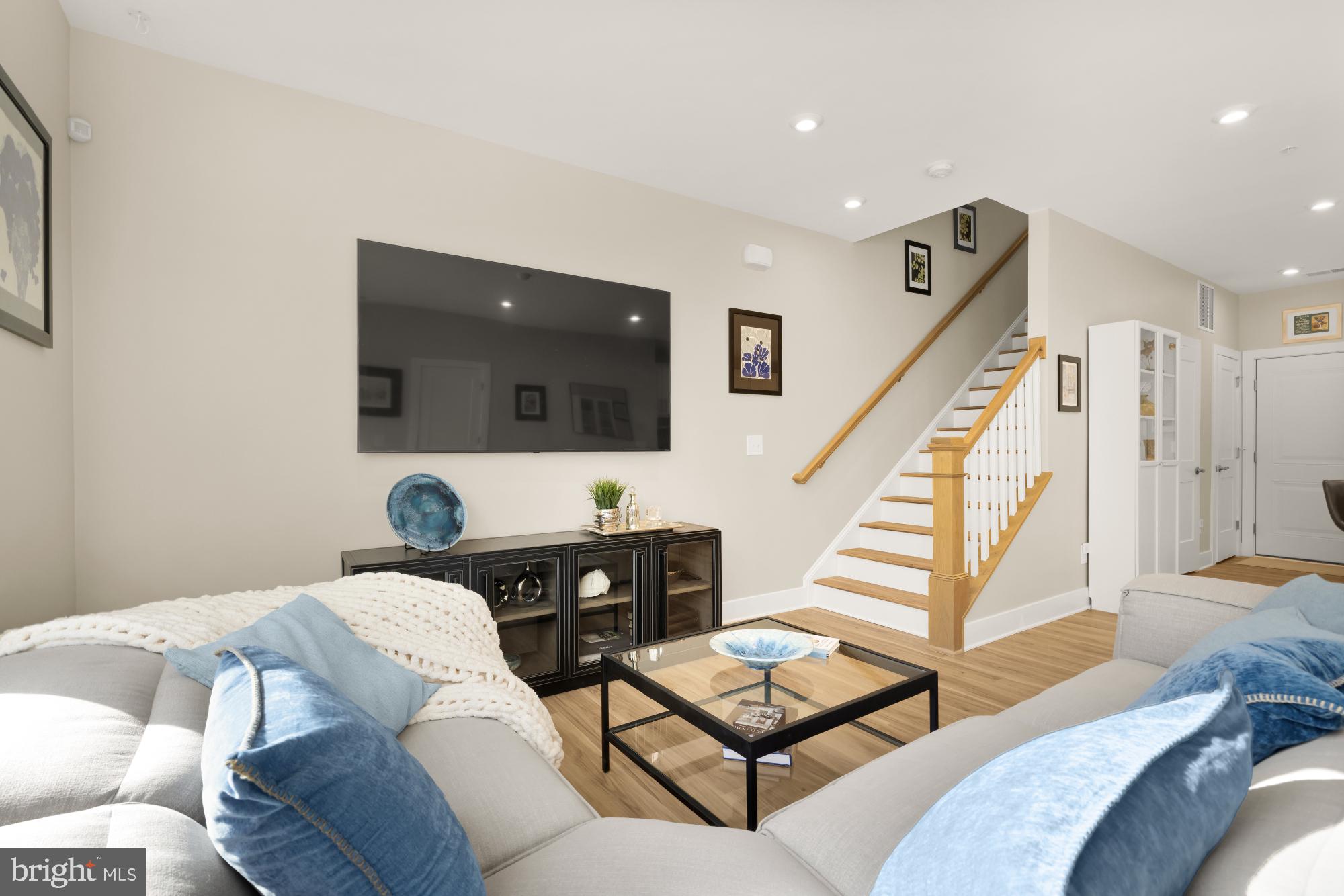 1704 Bandit Loop, Unit 20A Reston, VA 20190 - Photo 3 of 32 a living room with furniture and a flat screen tv