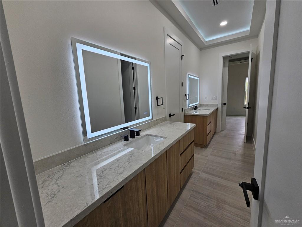 1821 South Middleton Street Edinburg, TX 78539 - Photo 14 of 26 a bathroom with a granite countertop sink a mirror and a