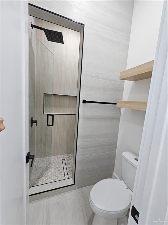 1821 South Middleton Street Edinburg, TX 78539 - Photo 16 of 26 a bathroom with a toilet and a shower