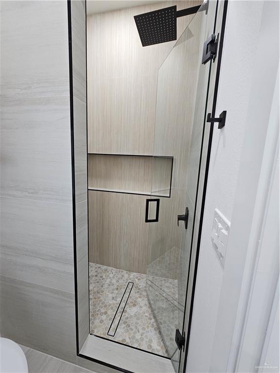 1821 South Middleton Street Edinburg, TX 78539 - Photo 20 of 26 a bathroom with a shower and a mirror