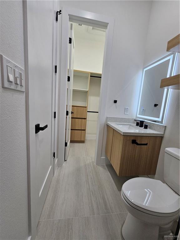 1821 South Middleton Street Edinburg, TX 78539 - Photo 21 of 26 a white toilet sitting next to a bathroom sink