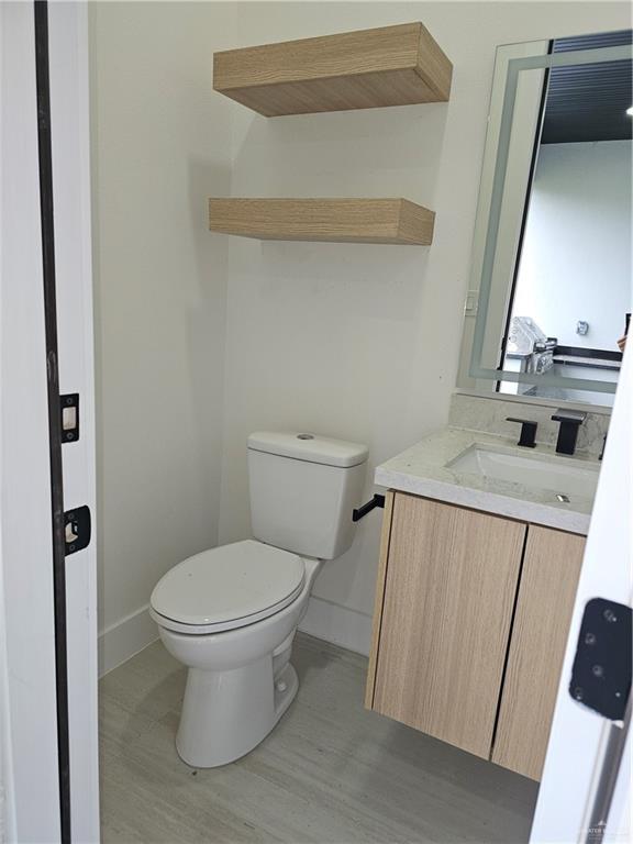 1821 South Middleton Street Edinburg, TX 78539 - Photo 24 of 26 a white toilet sitting next to a bathroom sink