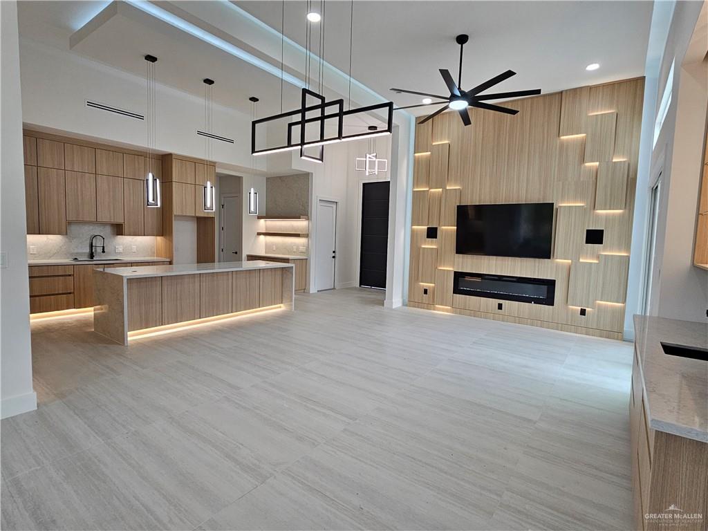 1821 South Middleton Street Edinburg, TX 78539 - Photo 3 of 26 a view of a living room a flat screen tv and kitchen view