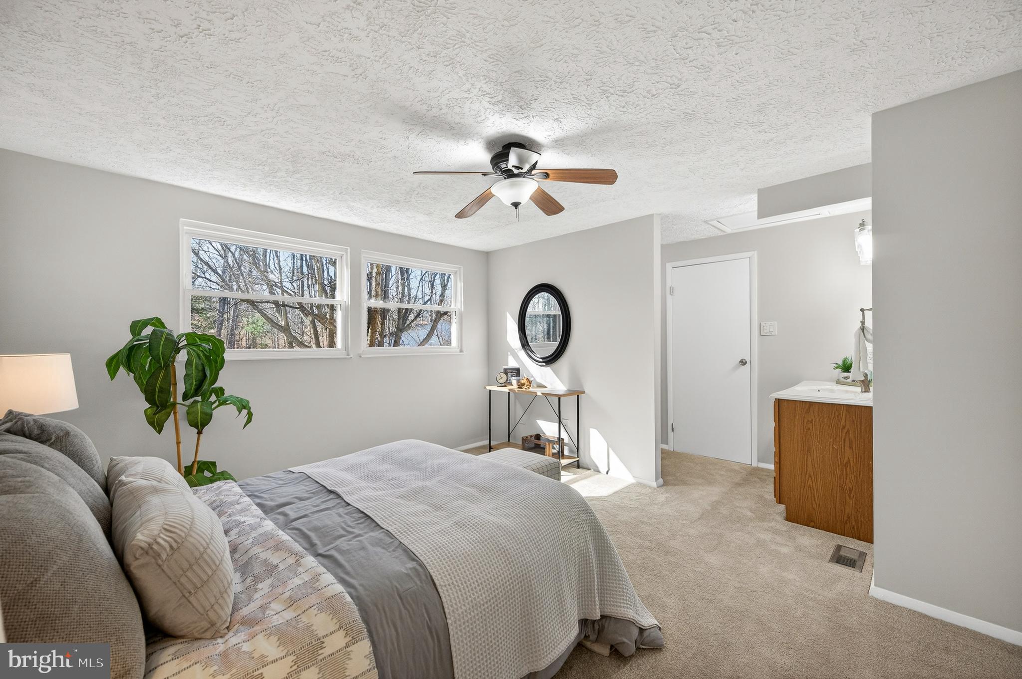 8225 Burning Forest Court Springfield, VA 22153 - Photo 17 of 43 a bedroom with a bed and a chandelier