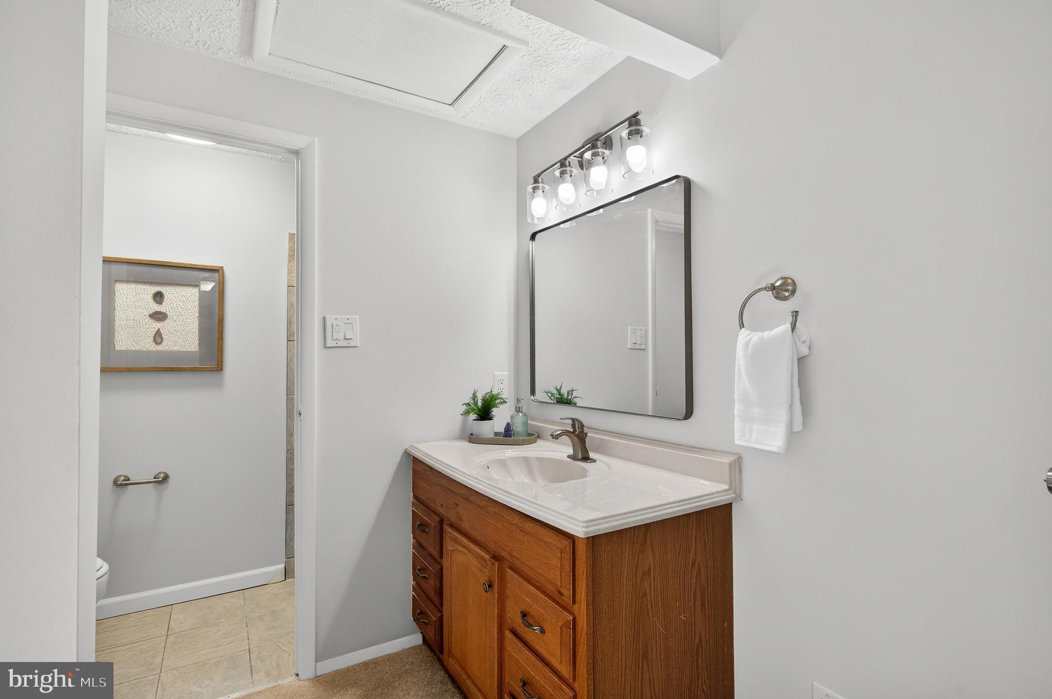 8225 Burning Forest Court Springfield, VA 22153 - Photo 21 of 43 a bathroom with a sink and a mirror