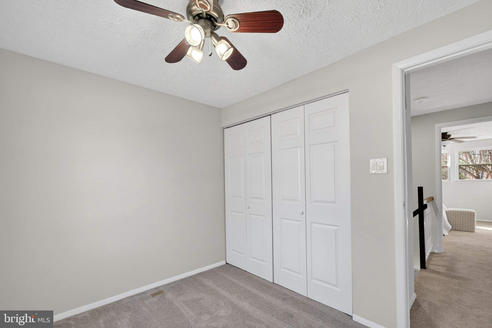 8225 Burning Forest Court Springfield, VA 22153 - Photo 25 of 43 an empty room with a chandelier fan and wooden floor
