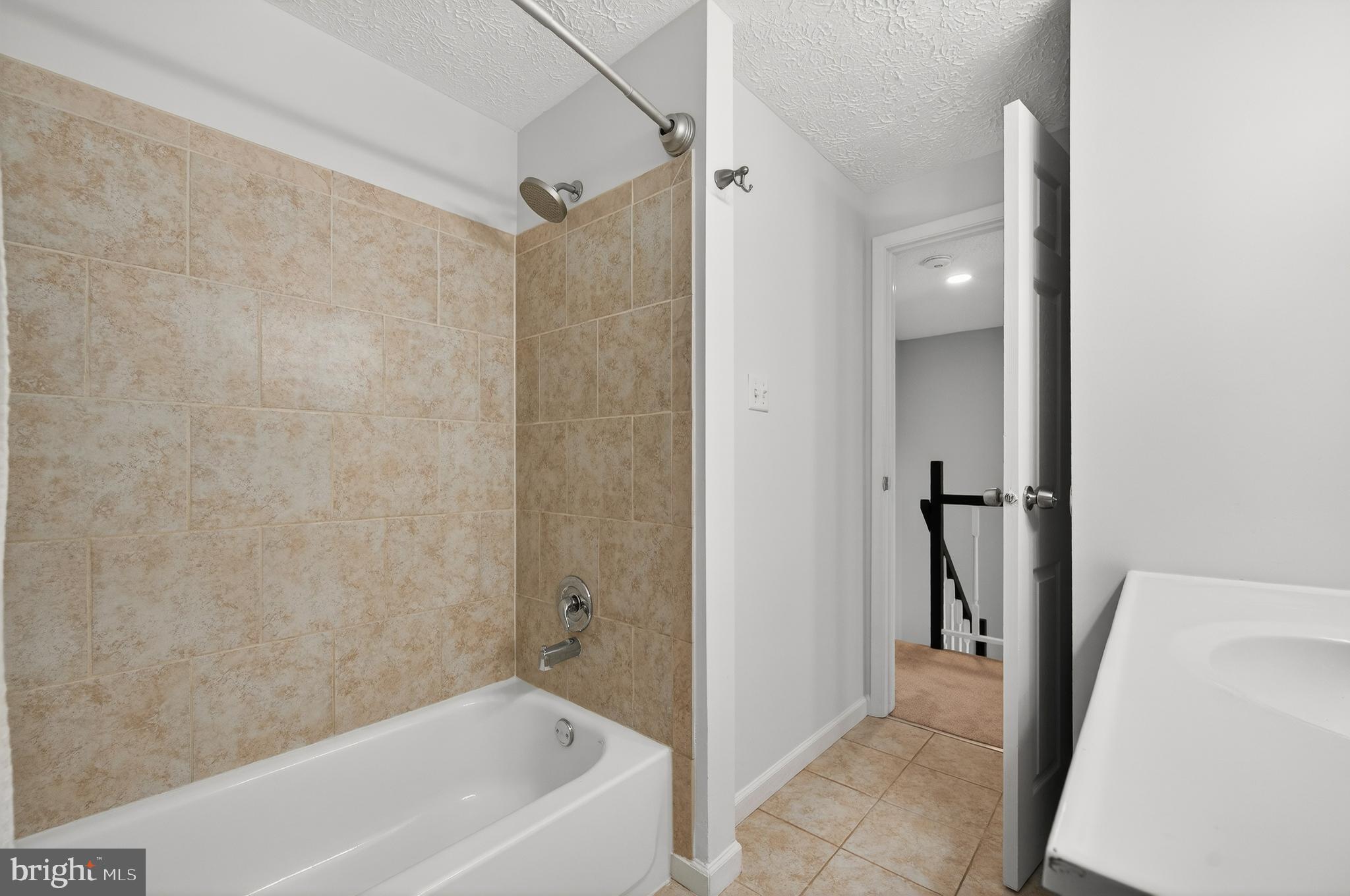 8225 Burning Forest Court Springfield, VA 22153 - Photo 27 of 43 a bathroom with a bathtub and a shower