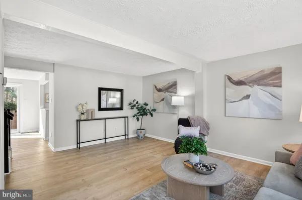 a living room with furniture potted plant and a table