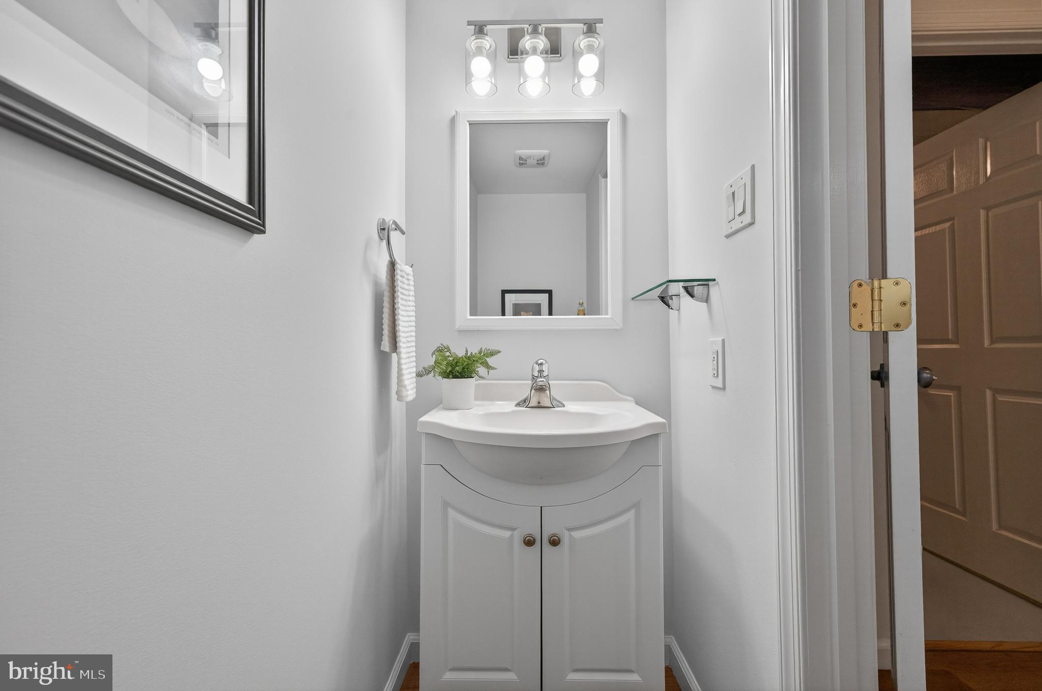 8225 Burning Forest Court Springfield, VA 22153 - Photo 32 of 43 a bathroom with a sink and a mirror