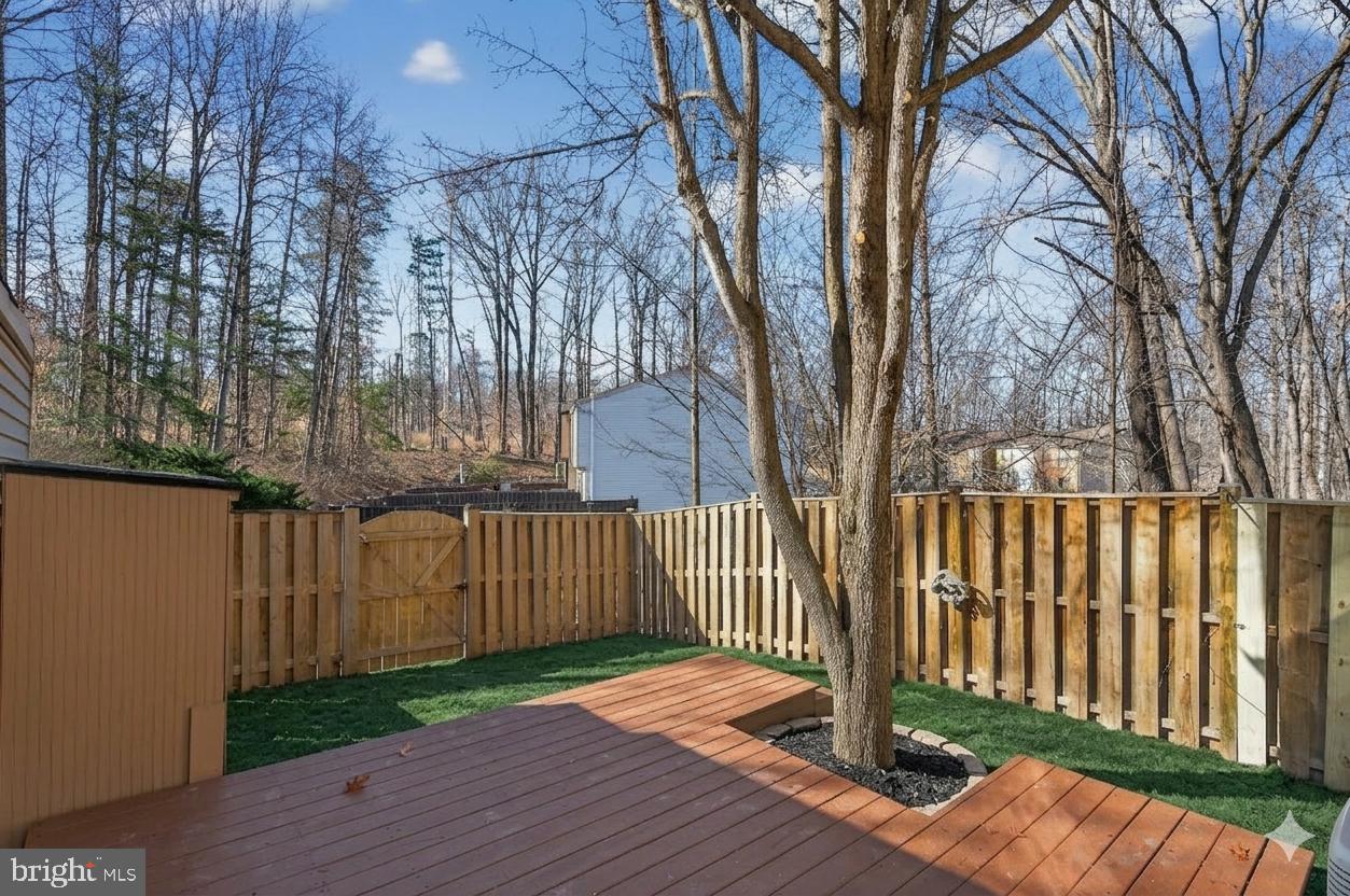 8225 Burning Forest Court Springfield, VA 22153 - Photo 35 of 43 a view of backyard with wooden floor and fence