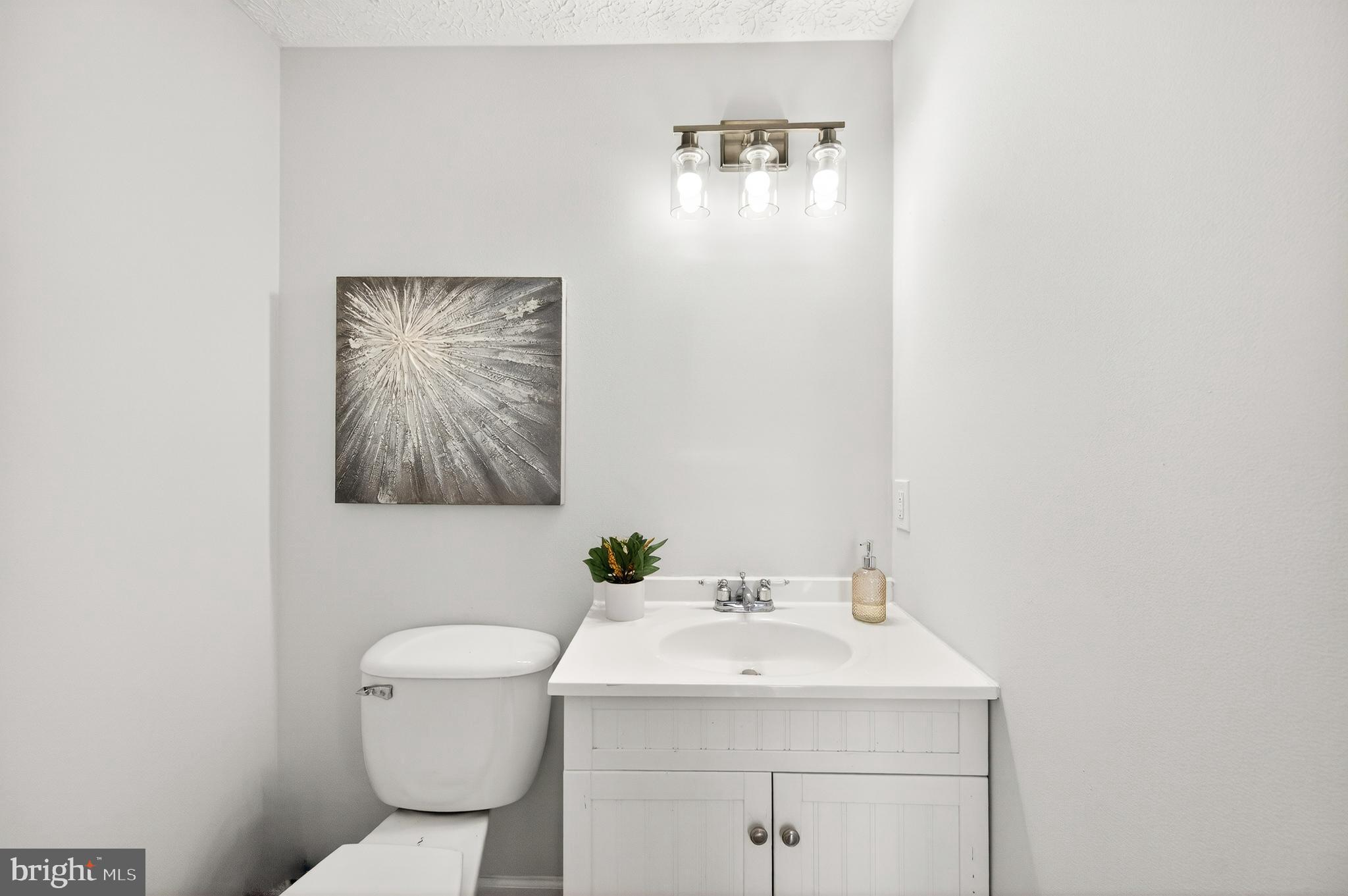 8225 Burning Forest Court Springfield, VA 22153 - Photo 6 of 43 a bathroom with a toilet sink and mirror