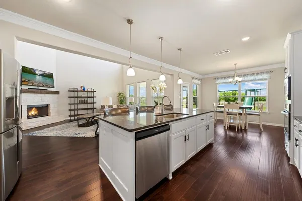 a kitchen with counter top space a sink appliances and cabinets