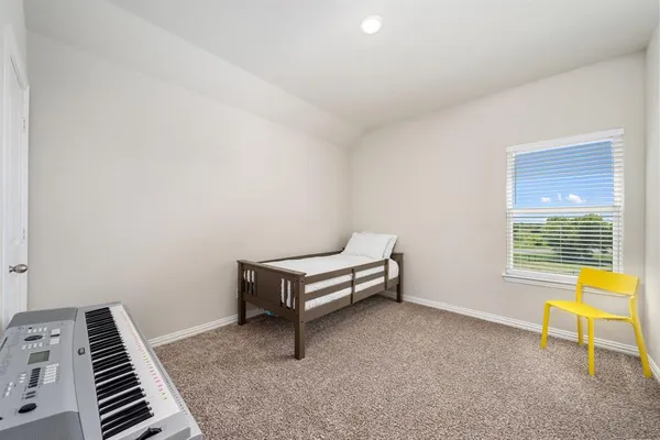 a bedroom with furniture and a baby crib