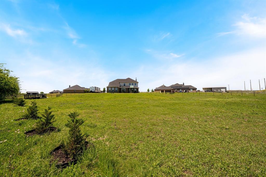 12700 Cold Spring Lane Ponder, TX 76259 - Photo 28 of 30 Upgraded 22 trees were planted around the perimeter of the 1+ acre lot in back yard for extra privacy.