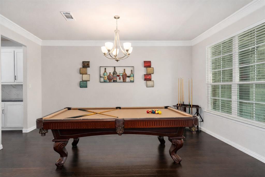 12700 Cold Spring Lane Ponder, TX 76259 - Photo 5 of 30 The dining room doubles as a downstairs billiards play area. AI enhanced.