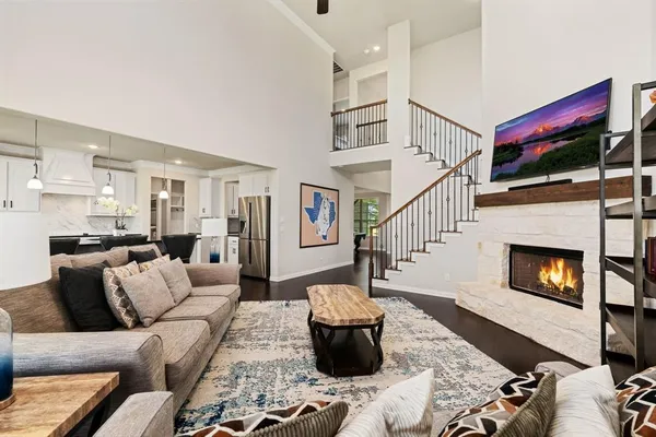 a living room with furniture and floor to ceiling window