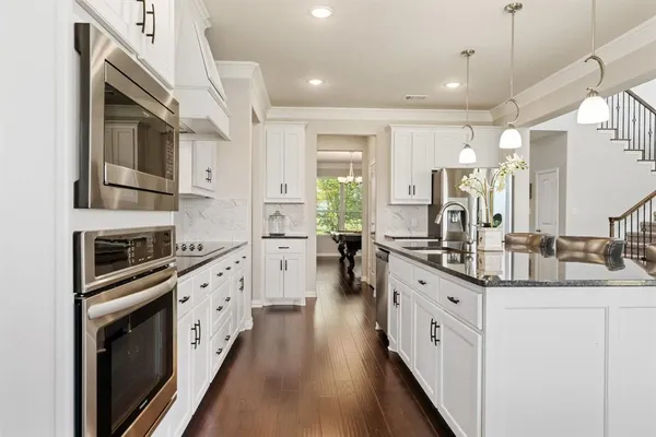 a kitchen with counter top space and wooden floor