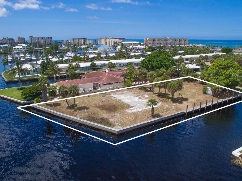 936 Gibbs Road Venice, FL 34285 - Photo 1 of 1 Sky View looking from the North East. 106' of 2' wide seawall on Roberts Bay and 180' of 2' seawall on canal with 100' of Composite Deck Board Docking.