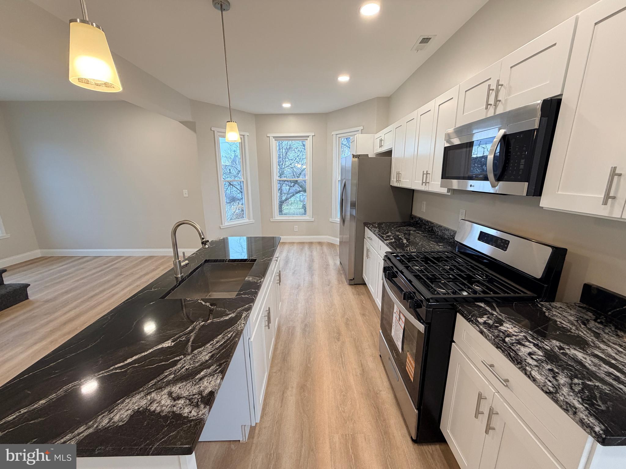 3 East Overlea Avenue, Unit 3 Baltimore, MD 21206 - Photo 12 of 45 a kitchen with stainless steel appliances granite countertop a stove and a sink