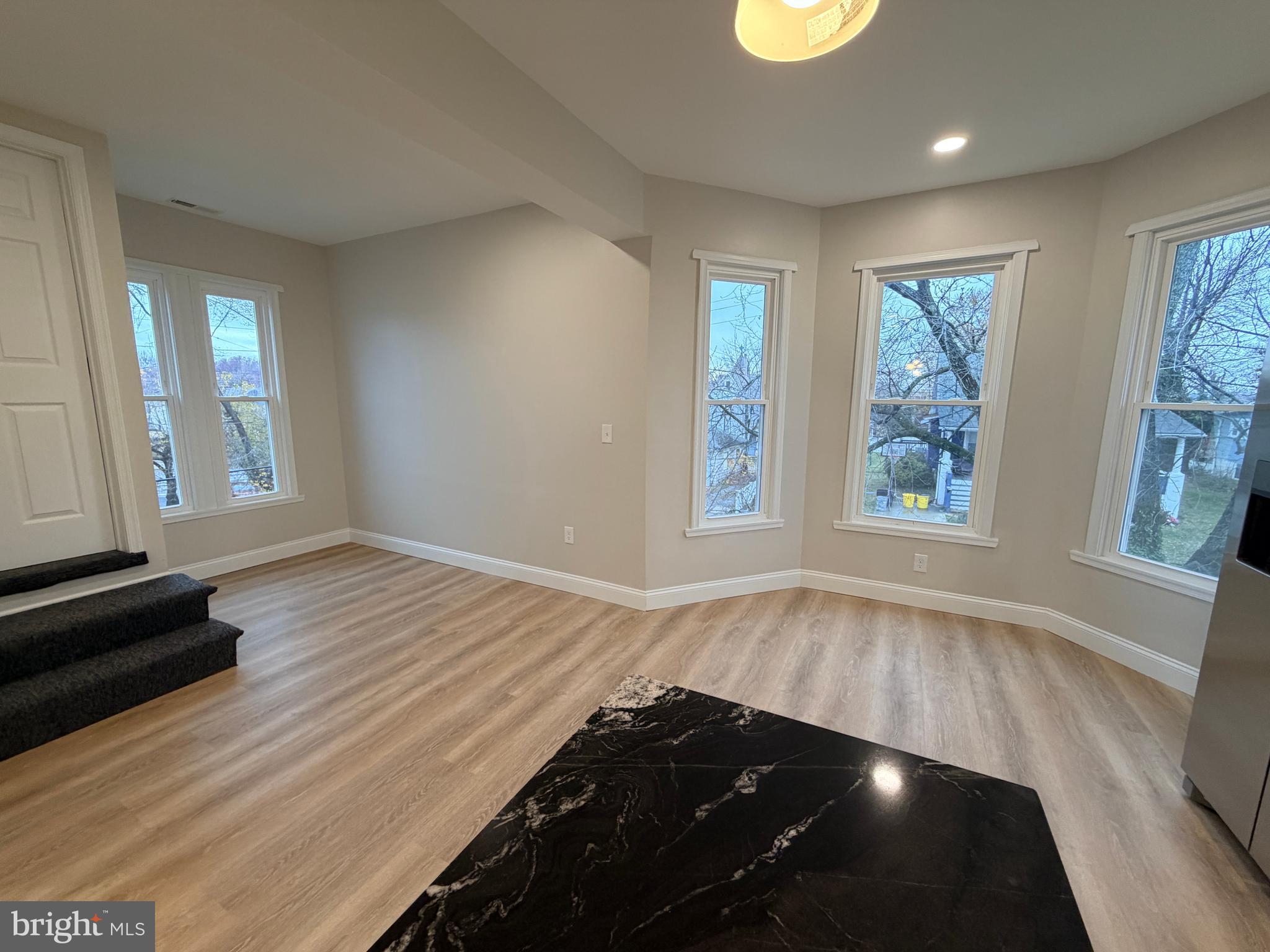 3 East Overlea Avenue, Unit 3 Baltimore, MD 21206 - Photo 18 of 45 wooden floor in an empty room with a window
