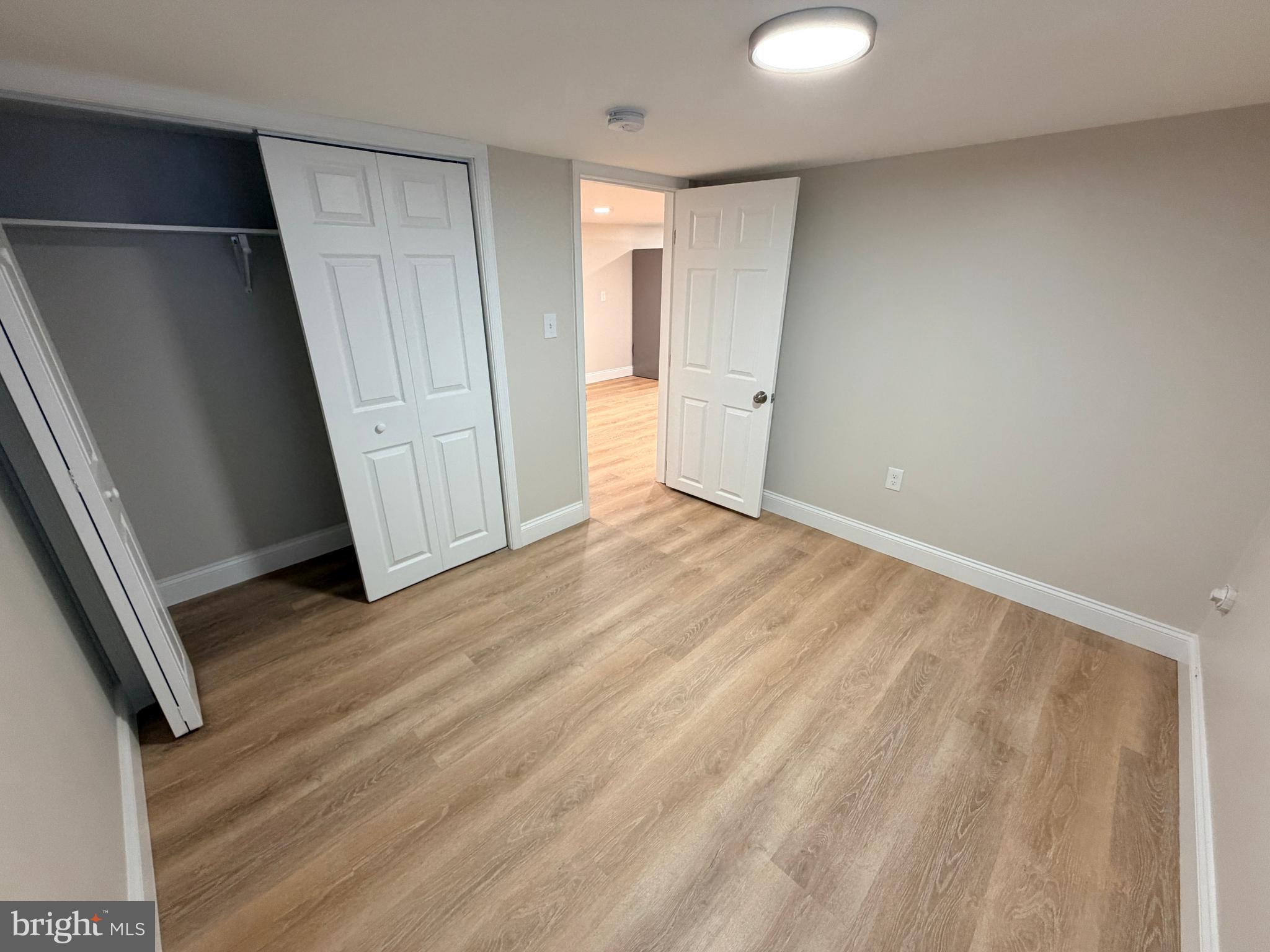 3 East Overlea Avenue, Unit 3 Baltimore, MD 21206 - Photo 19 of 45 a view of an empty room with wooden floor and a window