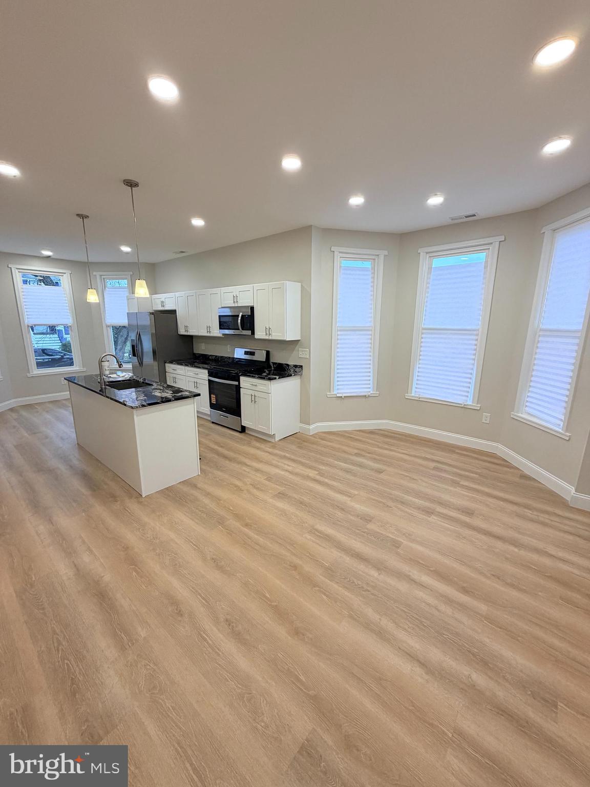 3 East Overlea Avenue, Unit 3 Baltimore, MD 21206 - Photo 20 of 45 a view of a kitchen with kitchen island wooden floor center island and stainless steel appliances