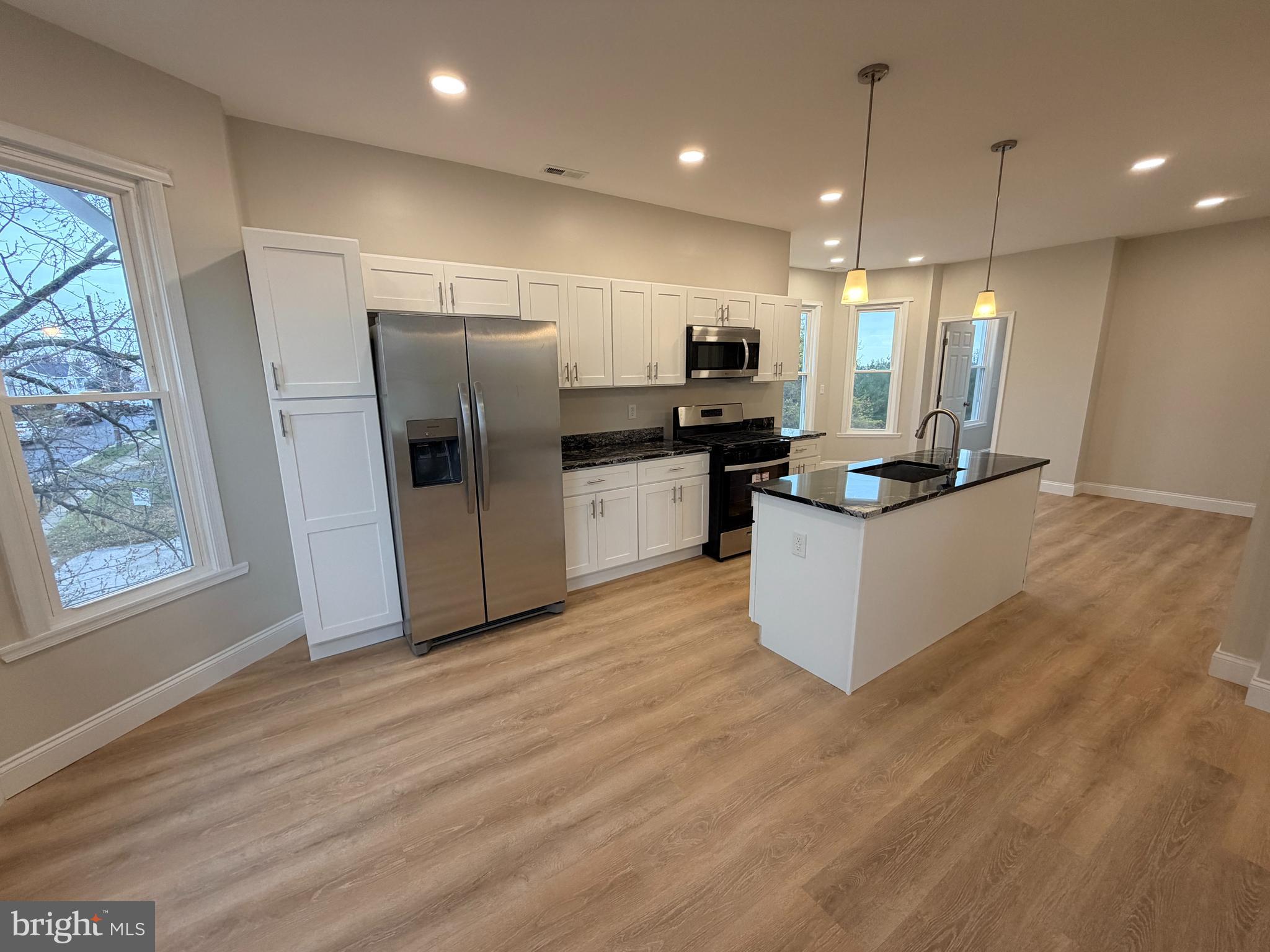 3 East Overlea Avenue, Unit 3 Baltimore, MD 21206 - Photo 25 of 45 a kitchen with stainless steel appliances a refrigerator sink and microwave