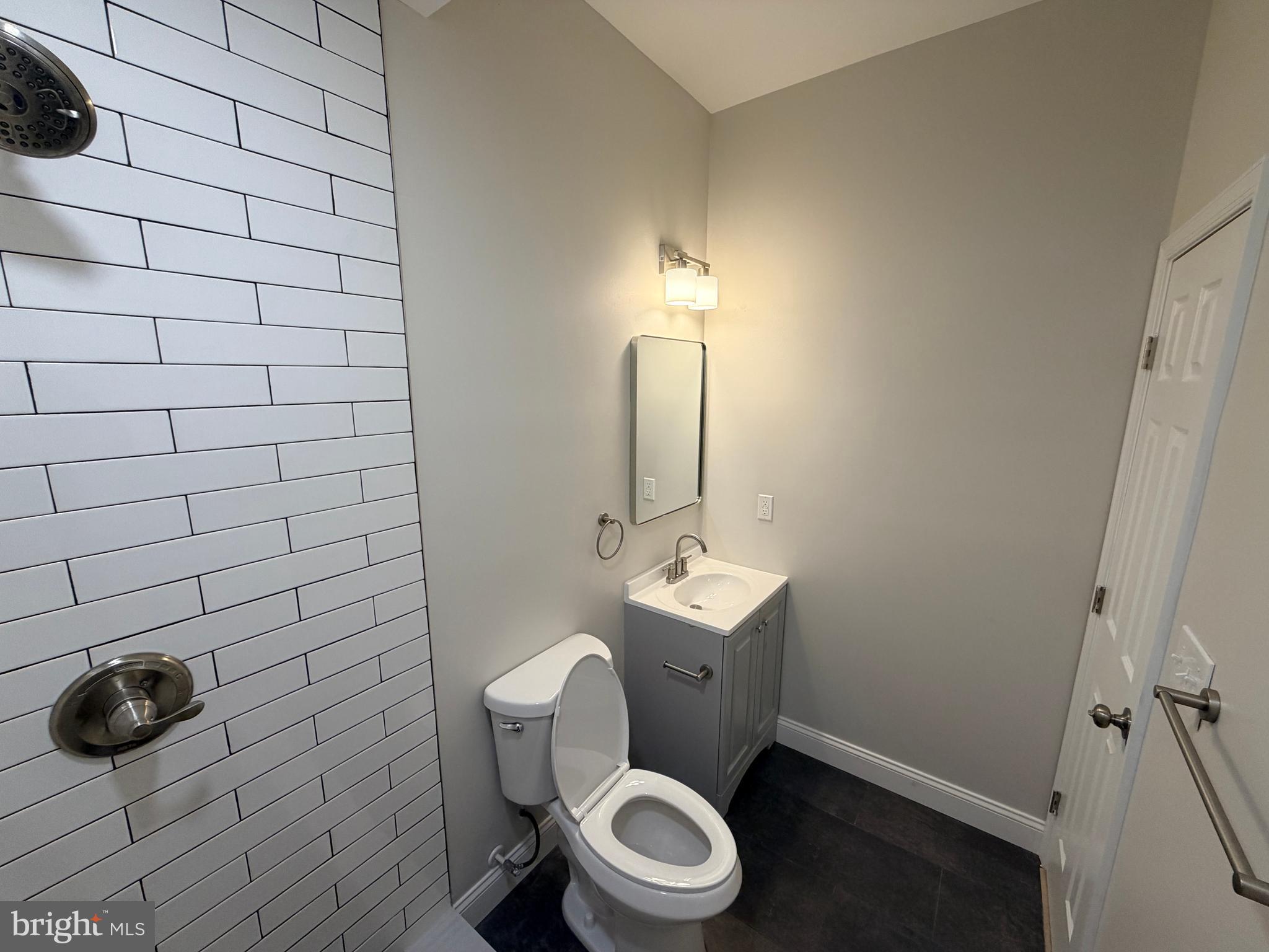3 East Overlea Avenue, Unit 3 Baltimore, MD 21206 - Photo 26 of 45 a bathroom with a toilet a sink and mirror