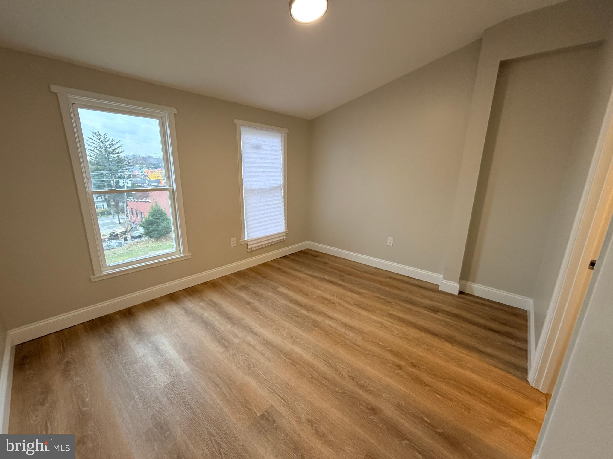 3 East Overlea Avenue, Unit 3 Baltimore, MD 21206 - Photo 39 of 45 a view of an empty room with wooden floor and a window