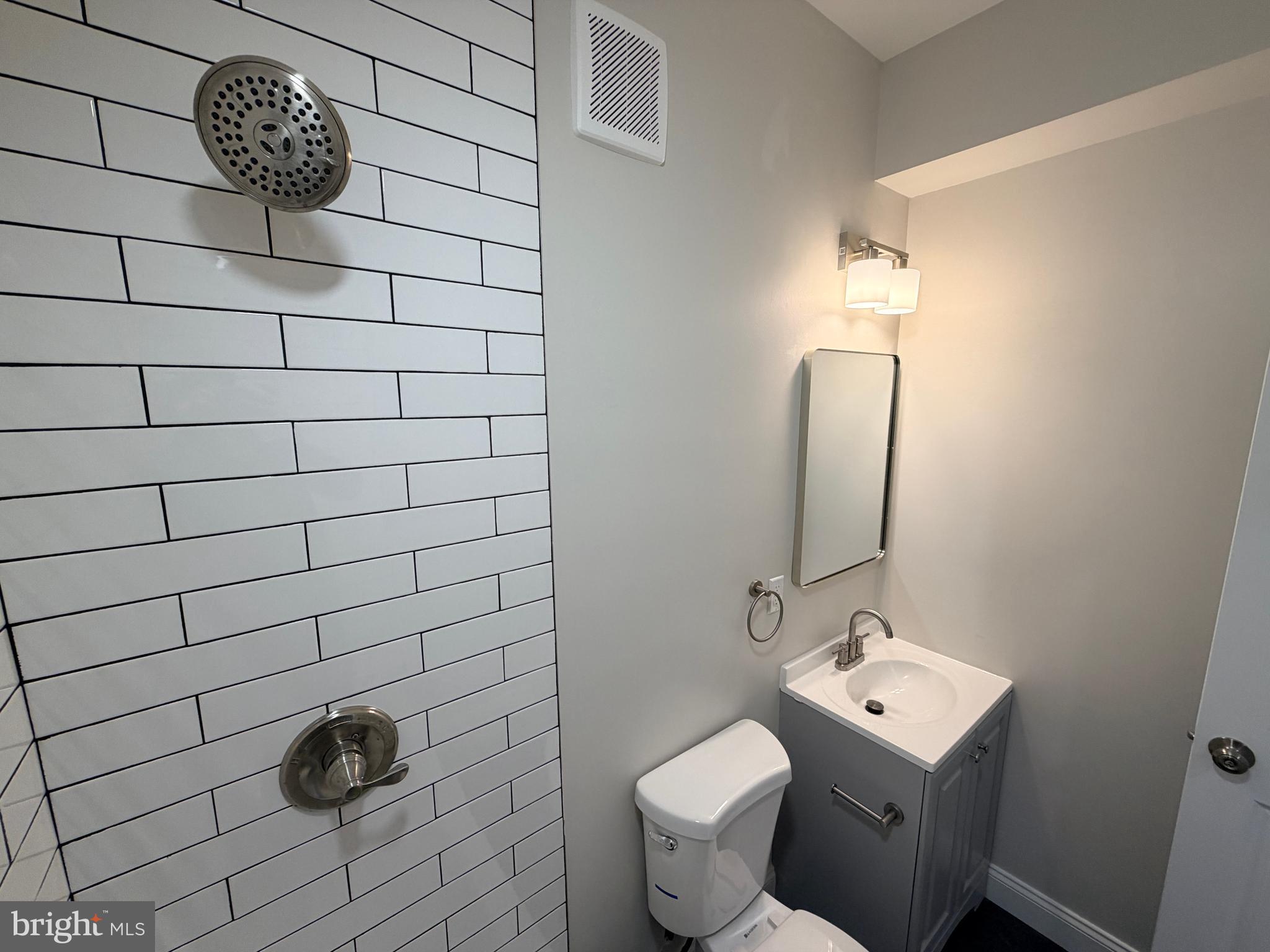 3 East Overlea Avenue, Unit 3 Baltimore, MD 21206 - Photo 41 of 45 a bathroom with a toilet a sink and mirror