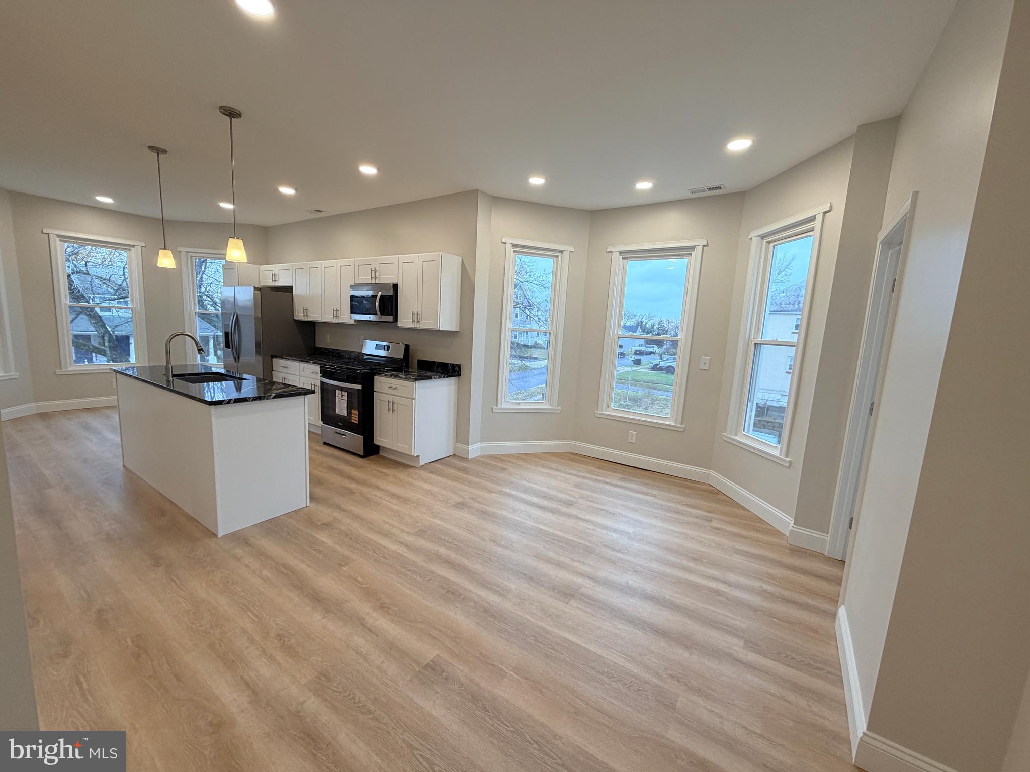 3 East Overlea Avenue, Unit 3 Baltimore, MD 21206 - Photo 6 of 45 a view of kitchen with kitchen island wooden floor center island and stainless steel appliances