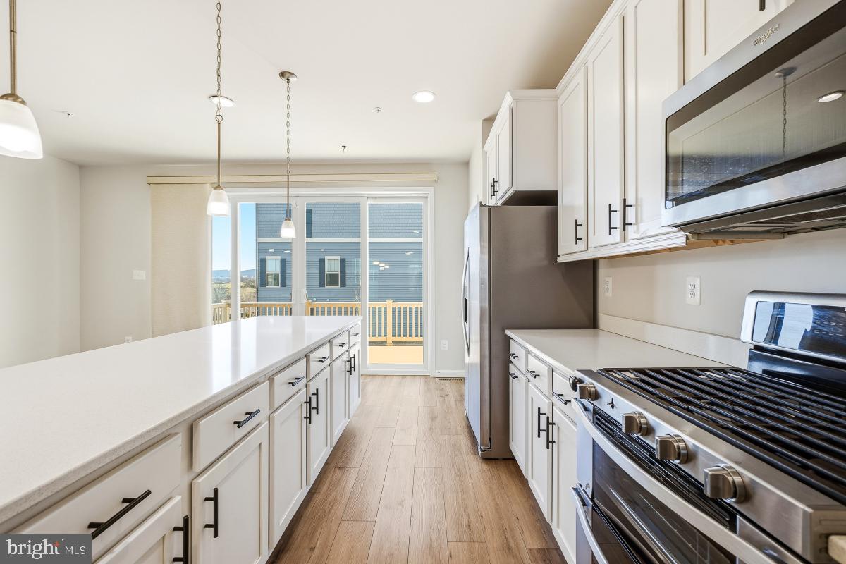5820 Imperial Drive Frederick, MD 21703 - Photo 12 of 30 a kitchen with stainless steel appliances granite countertop a stove and a sink