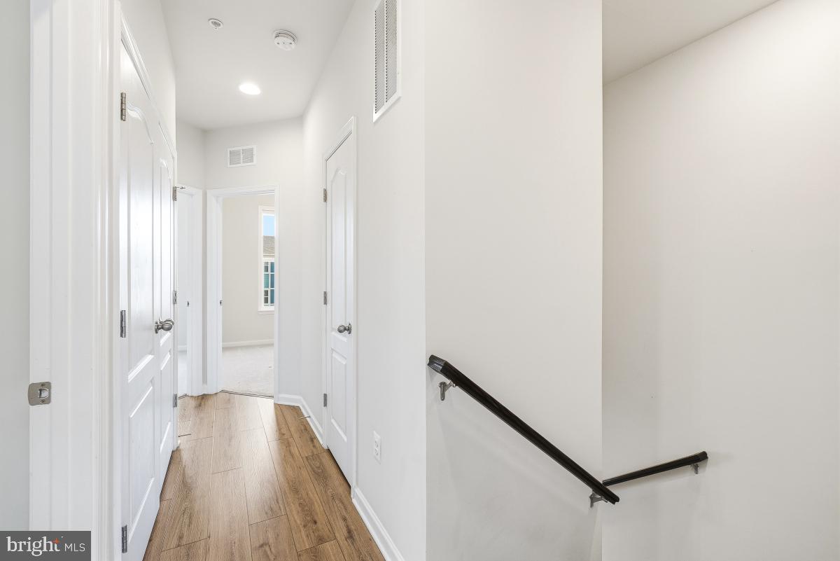 5820 Imperial Drive Frederick, MD 21703 - Photo 20 of 30 a view of a hallway with wooden floor and staircase
