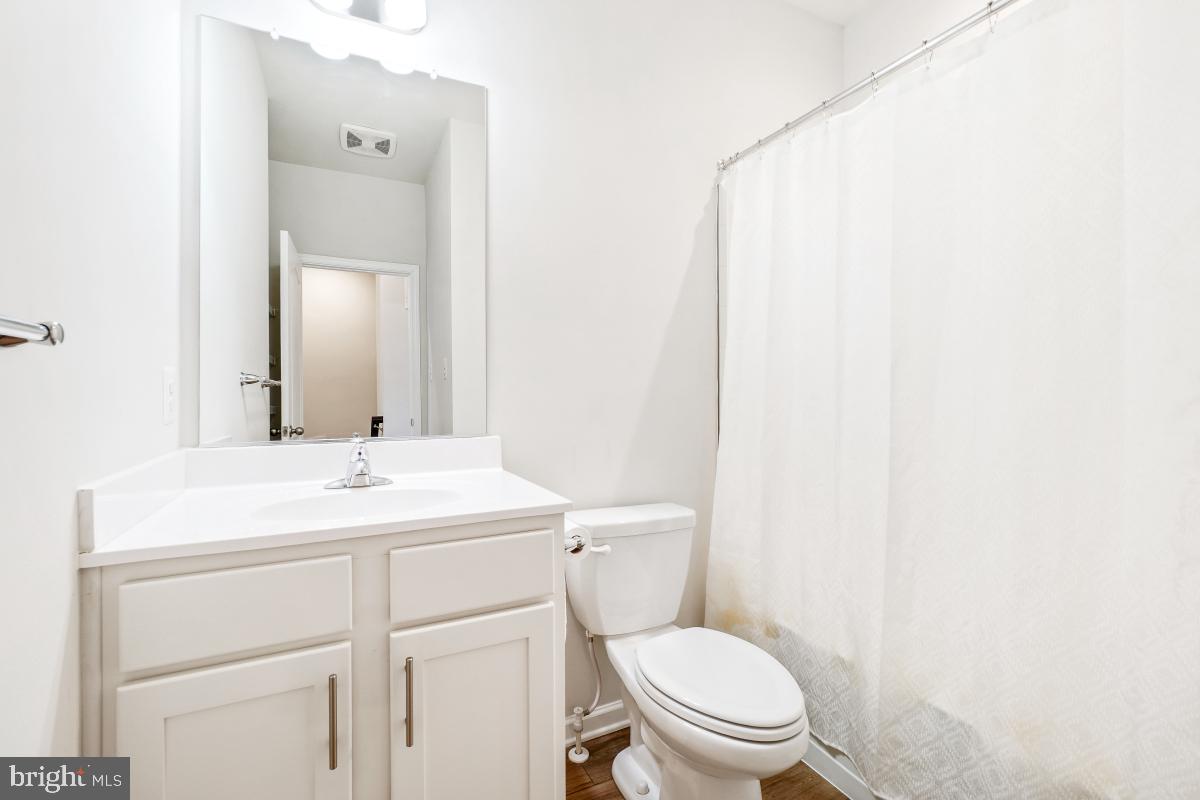 5820 Imperial Drive Frederick, MD 21703 - Photo 22 of 30 a bathroom with a toilet a sink and a mirror