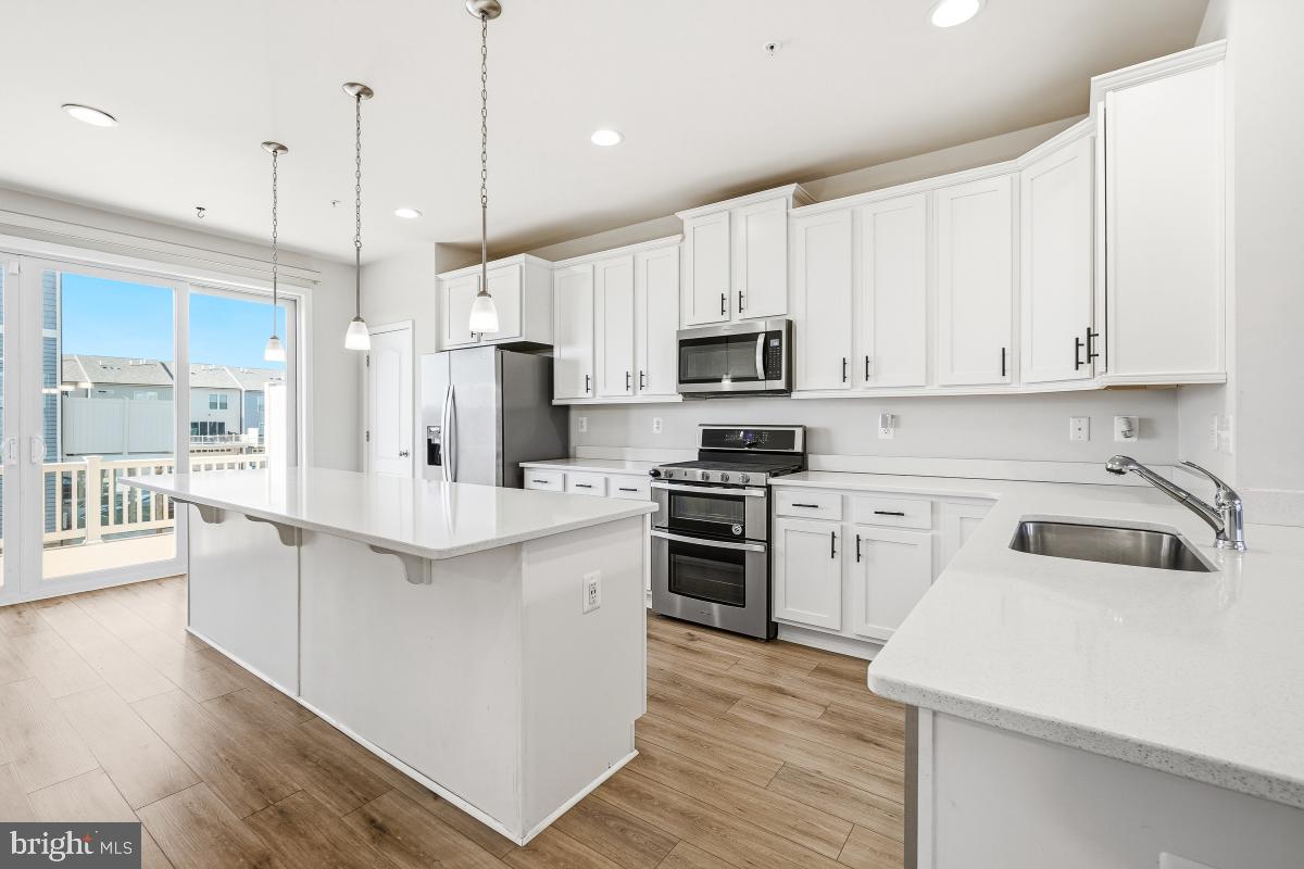 5820 Imperial Drive Frederick, MD 21703 - Photo 8 of 30 a kitchen with kitchen island white cabinets stainless steel appliances and sink