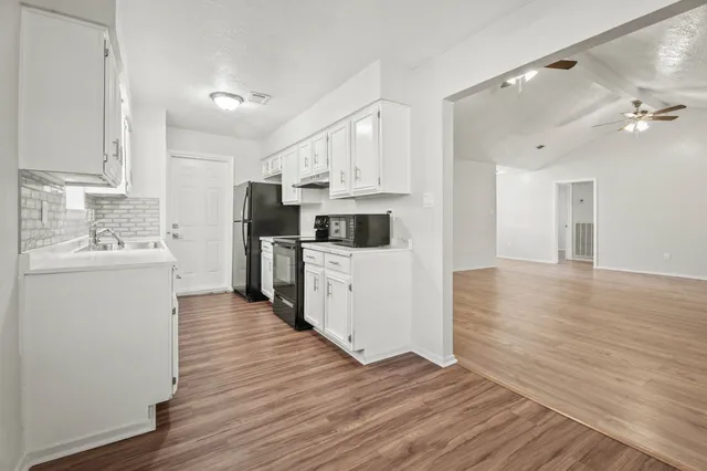 a kitchen with stainless steel appliances granite countertop a sink and a stove