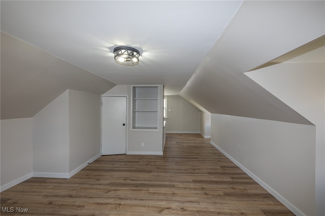 16002 Turney Road Maple Heights, OH 44137 - Photo 24 of 29 Additional living space with light wood-style floors and vaulted ceiling