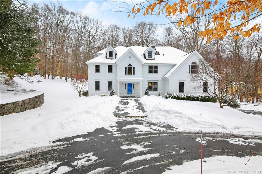 10 Side Hill Road Westport, CT 06880 - Photo 1 of 1 a view of a white house with a snow on the road
