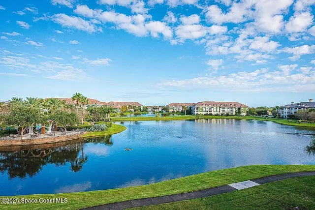 a view of a lake with houses in the back