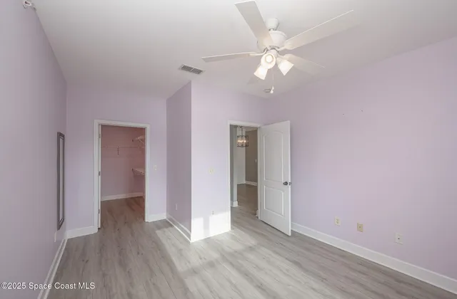 a view of a patio with table and chairs potted plants and palm trees
