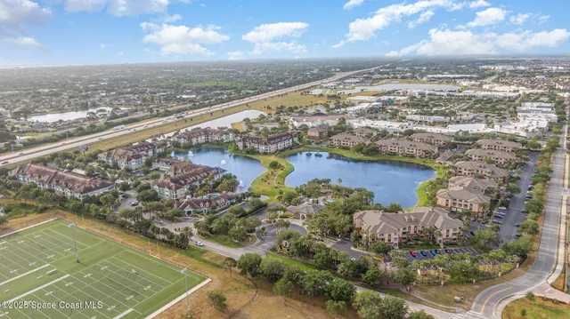 a row of palm trees and a tree in front of the house