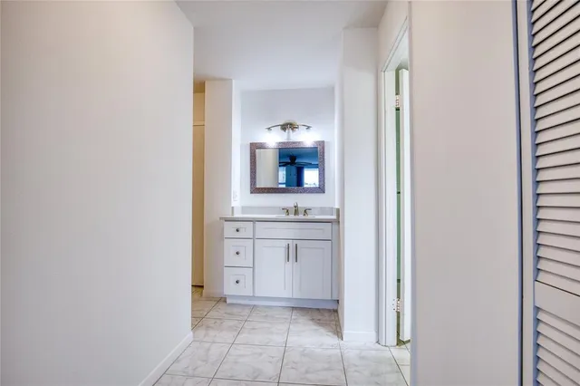 a room with a sink and a mirror