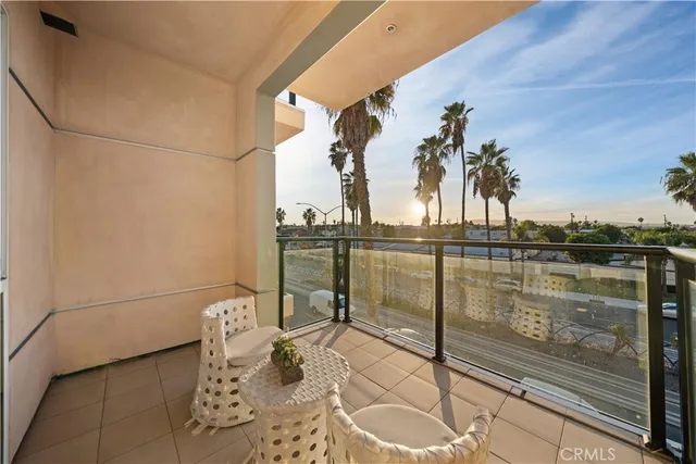 a view of a balcony with chair and table in the balcony