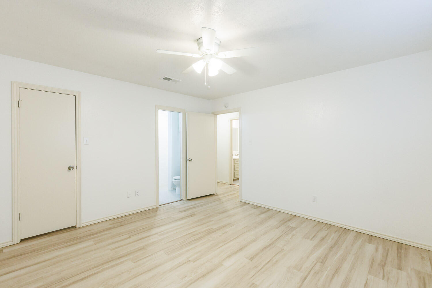 4407 75th Drive, Unit B Lubbock, TX 79424 - Photo 11 of 20 an empty room with wooden floor and windows