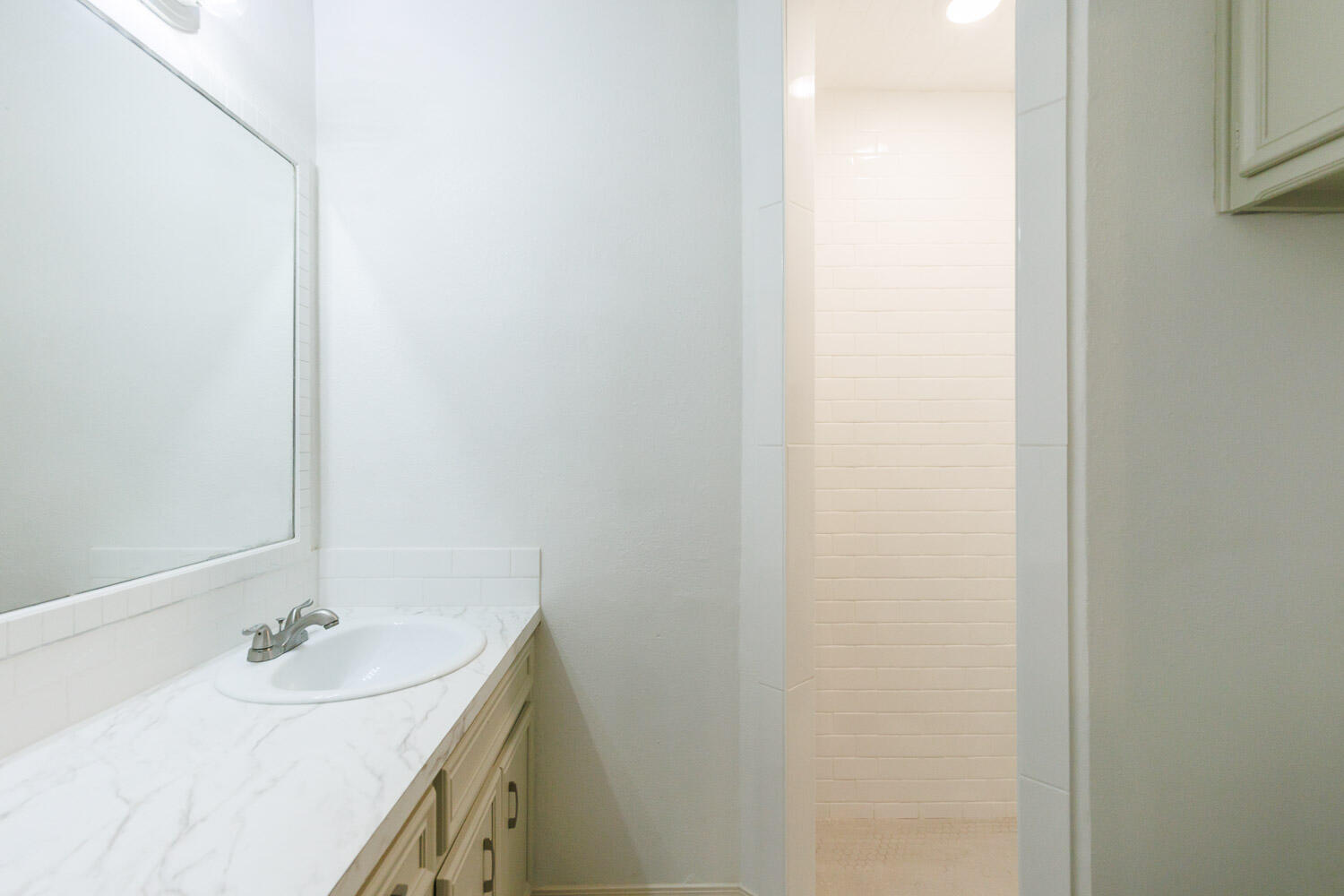 4407 75th Drive, Unit B Lubbock, TX 79424 - Photo 13 of 20 a bathroom with a sink and a mirror