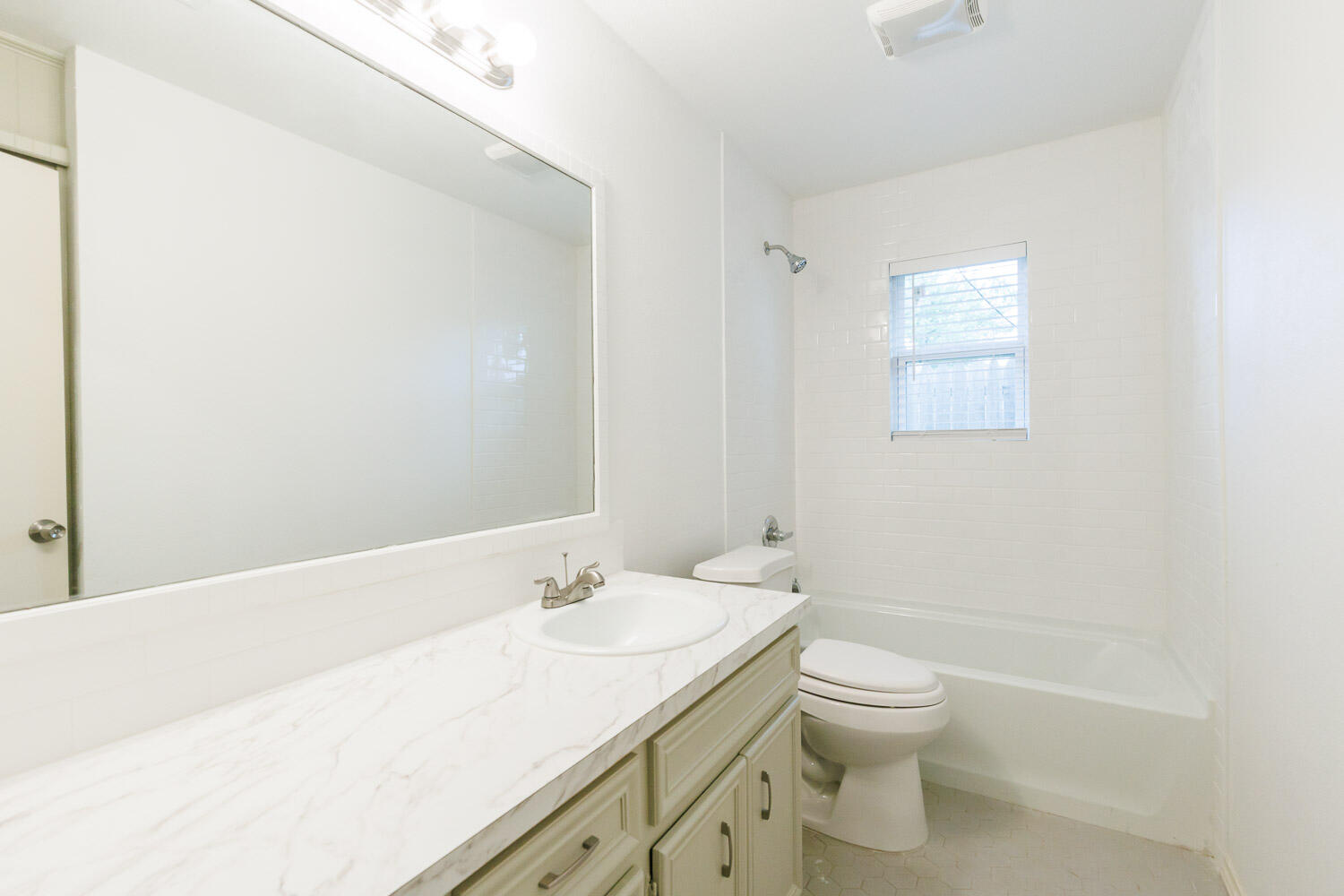 4407 75th Drive, Unit B Lubbock, TX 79424 - Photo 17 of 20 a bathroom with a granite countertop sink a toilet and shower