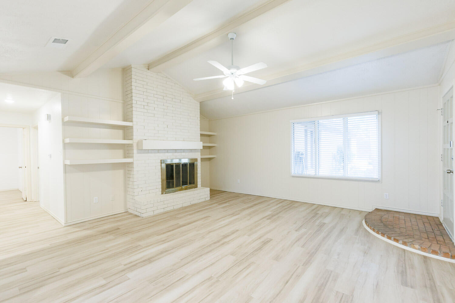 4407 75th Drive, Unit B Lubbock, TX 79424 - Photo 6 of 20 an empty room with a fireplace and windows