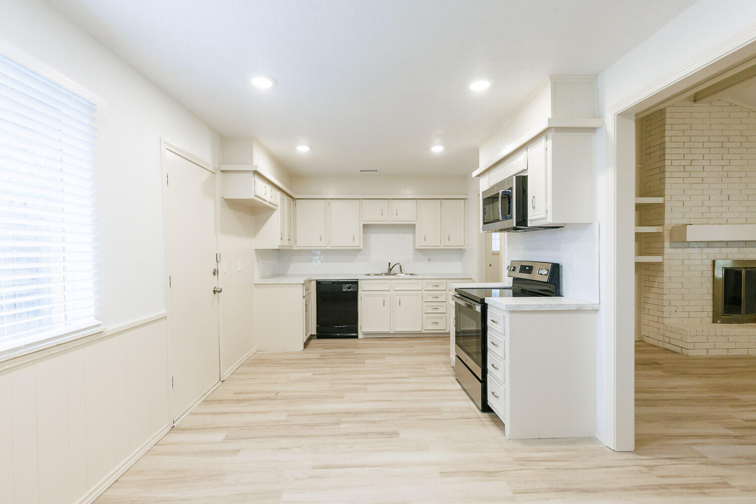 4407 75th Drive, Unit B Lubbock, TX 79424 - Photo 8 of 20 a kitchen with cabinets stainless steel appliances a sink and a window